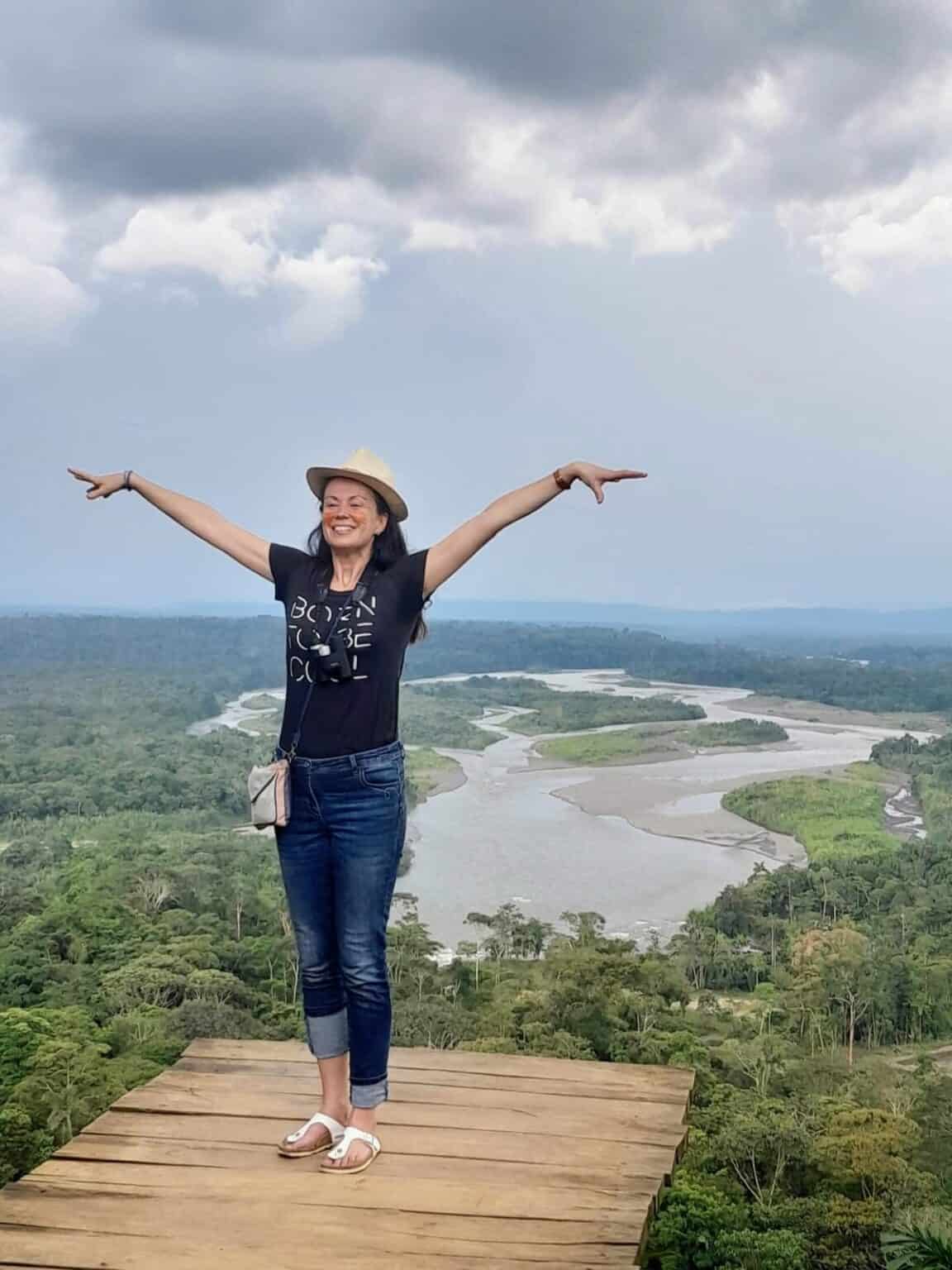 Woman overlooking rainforest and winding river vista