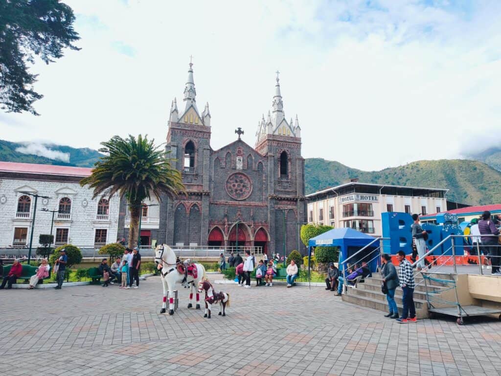 Town square with church, mountains, and white horse