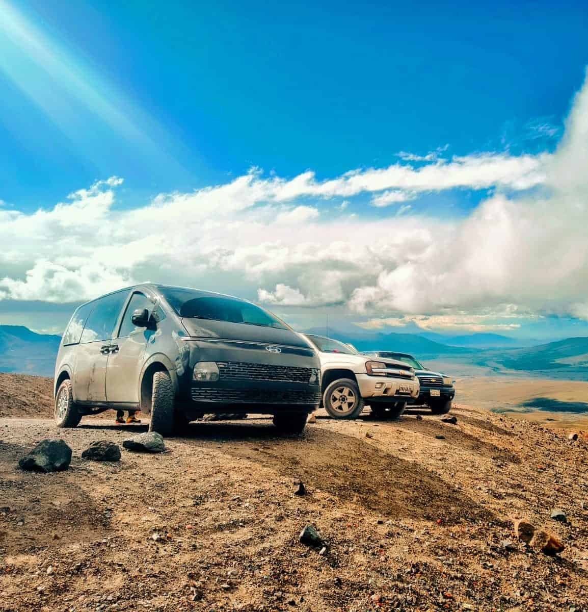 Two vehicles parked on a mountain overlook