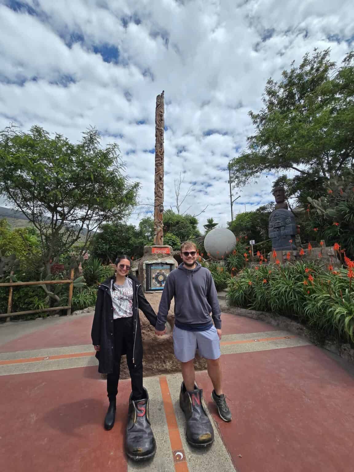 Couple standing on equator line monument in Ecuador