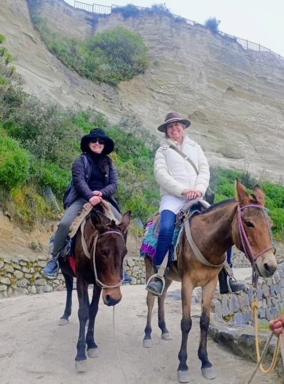 Two women riding horses on scenic trail