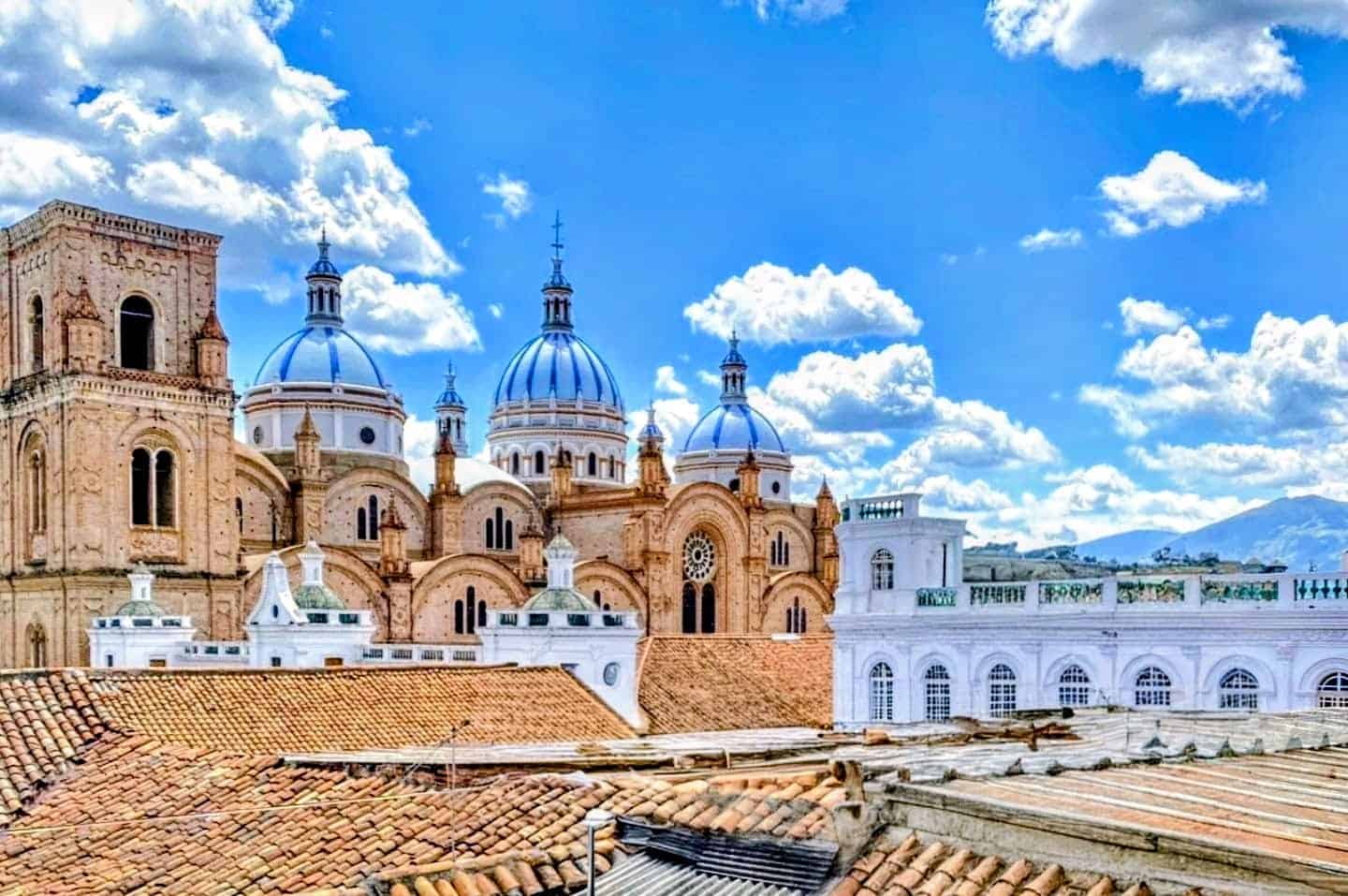 Historic cathedral with blue domes and tiled rooftops