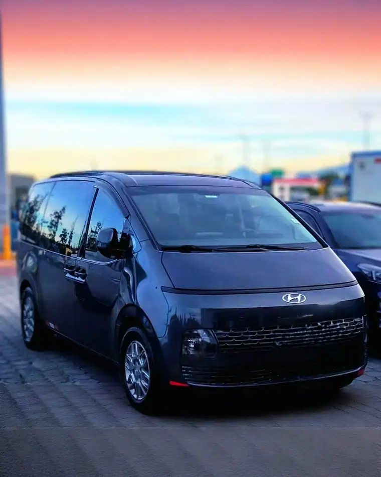 Dark blue Hyundai minivan at sunset