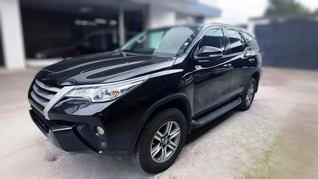 SUV negro aparcado frente a vivienda moderna