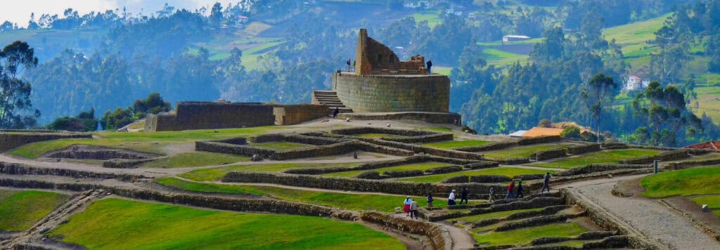 Incan ruins overlooking green Andean hills